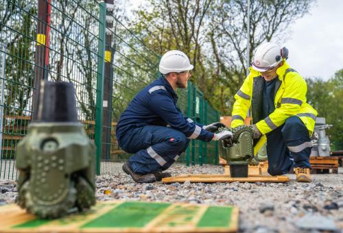 Workmen operating geothermal drill at Eden